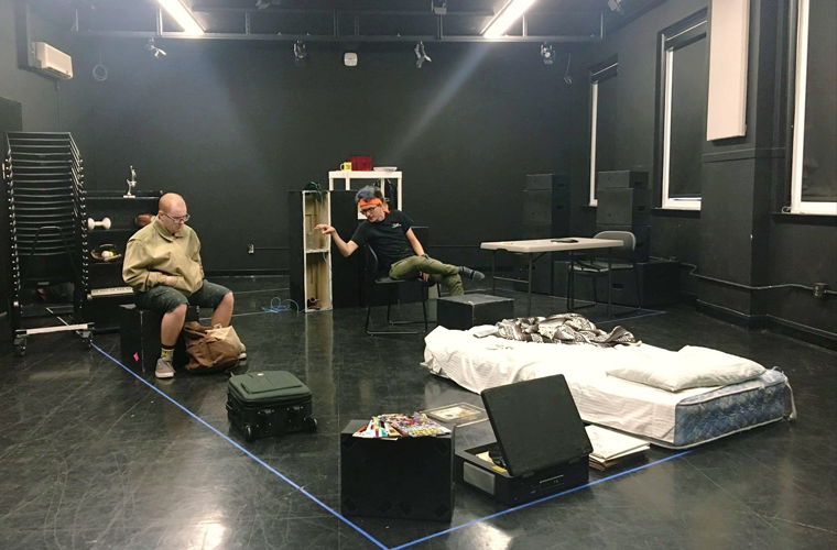 Two UL Lafayette theatre students in a black box theatre rehearsing for a performance