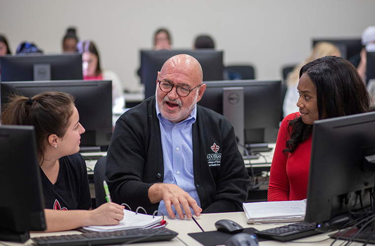 Students speaking with HIM professional