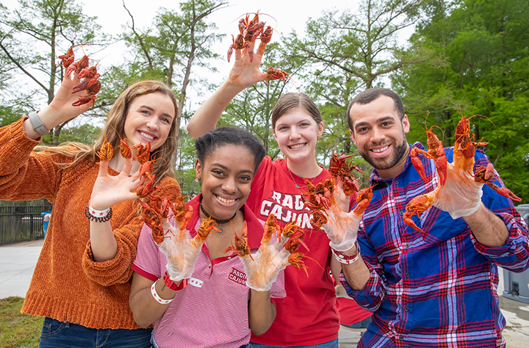 students with boiled crawfish on their fingers