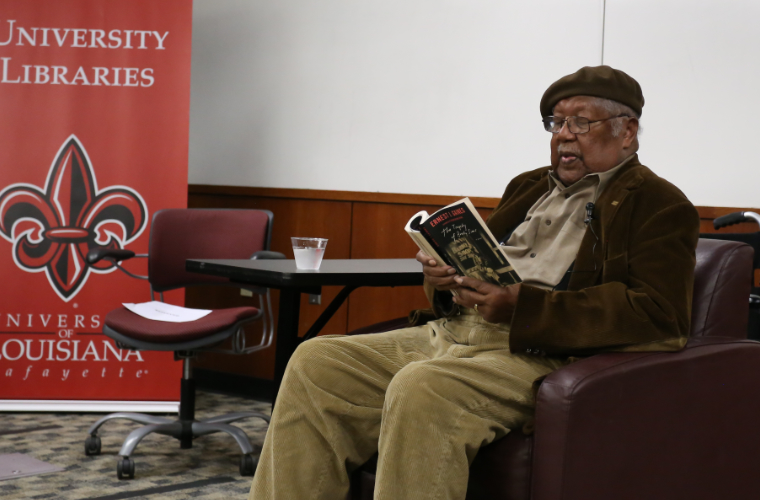 Ernest J. Gaines reading one of his books at an event in the UL Lafayette library.
