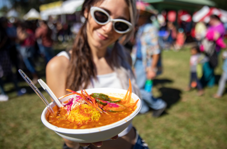 A woman showing her food at a Louisiana festival.