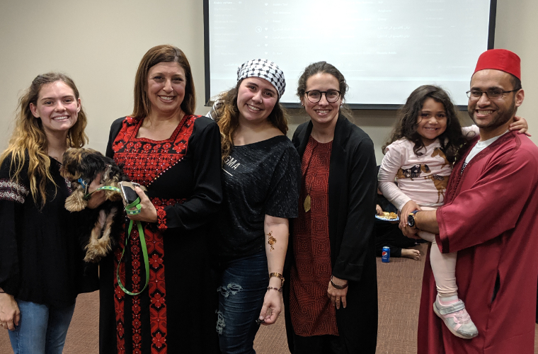 A group of people posing for a photo at an Arabic culture event at the University of Louisiana at Lafayette.