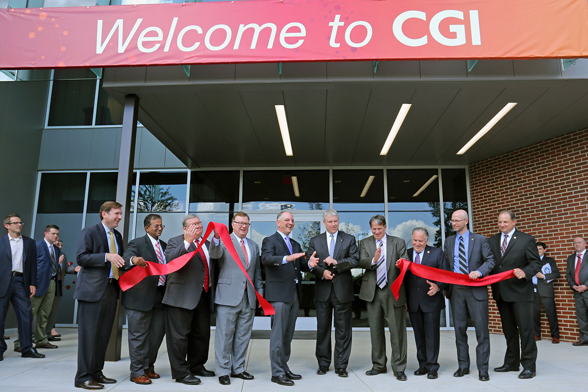 Row of Louisiana government and UL Lafayette research officials cutting a ribbon at CGI's opening
