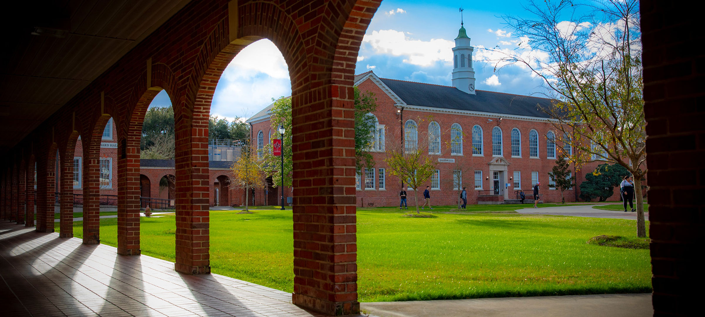A view of the University of Louisiana at Lafayette Stephens Hall through the arches of the alumni Walk of Honor