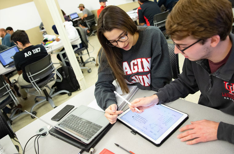 Informatics students working on an iPad at the University of Louisiana at Lafayette