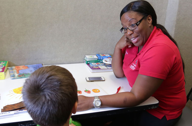 A University of Louisiana at Lafayette student in the speech pathology program works with a student in the on-campus speech language and hearing center.