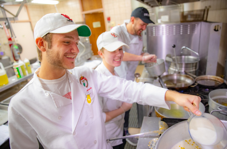 Students preparing food in a kitchen for the University of Louisiana at Lafayette Lunch Club.