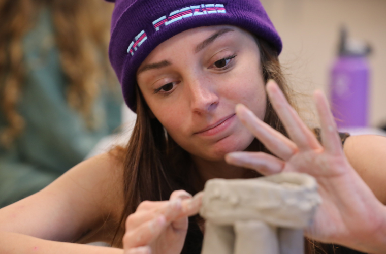 A University of Louisiana at Lafayette ceramics major in the visual arts program works with clay