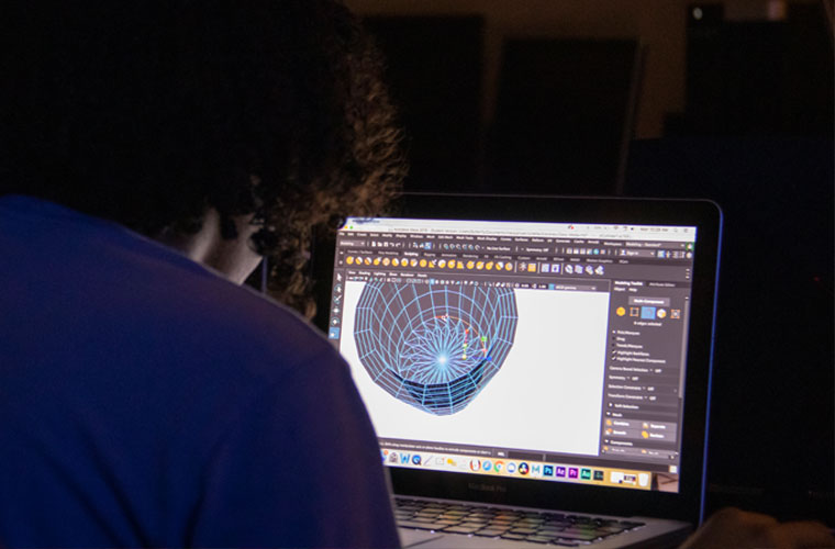 A student in the digital media art program at UL Lafayette works on a 3 D rendering on his computer