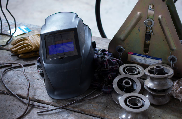 A welder's helmet and instruments that students in the sculpture program at UL Lafayette use