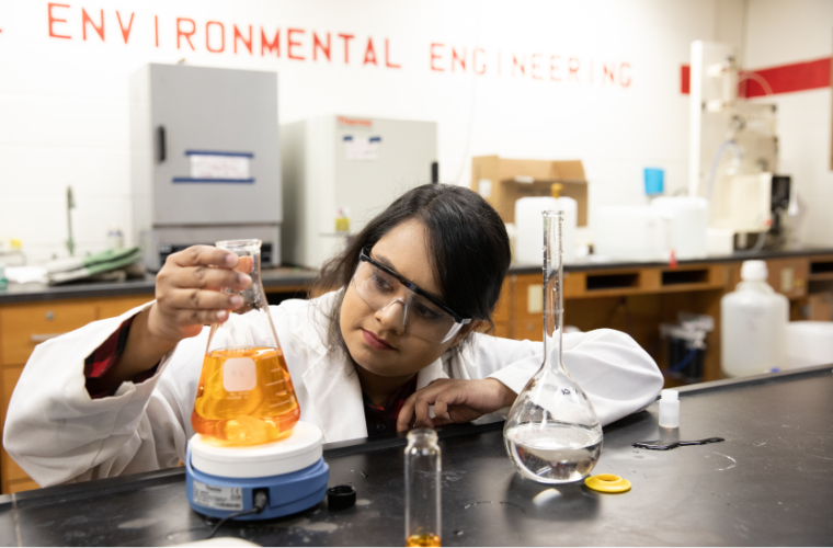 A University of Louisiana at Lafayette engineering student observes chemical processes in the environmental engineering lab.