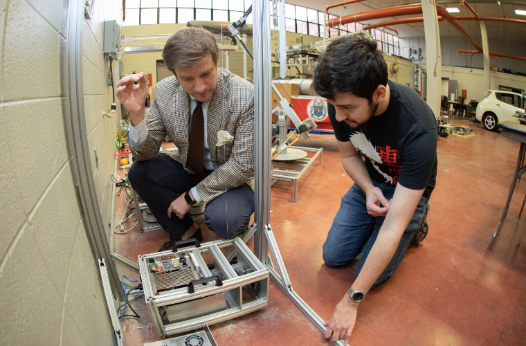 A professor and student working in the University of Louisiana at Lafayette robotics lab.