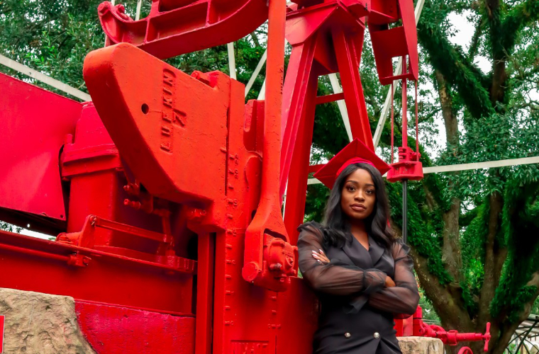 Electrical engineering student Erica Stewart stands with an engineering fixture on the university of Louisiana at Lafayette campus.