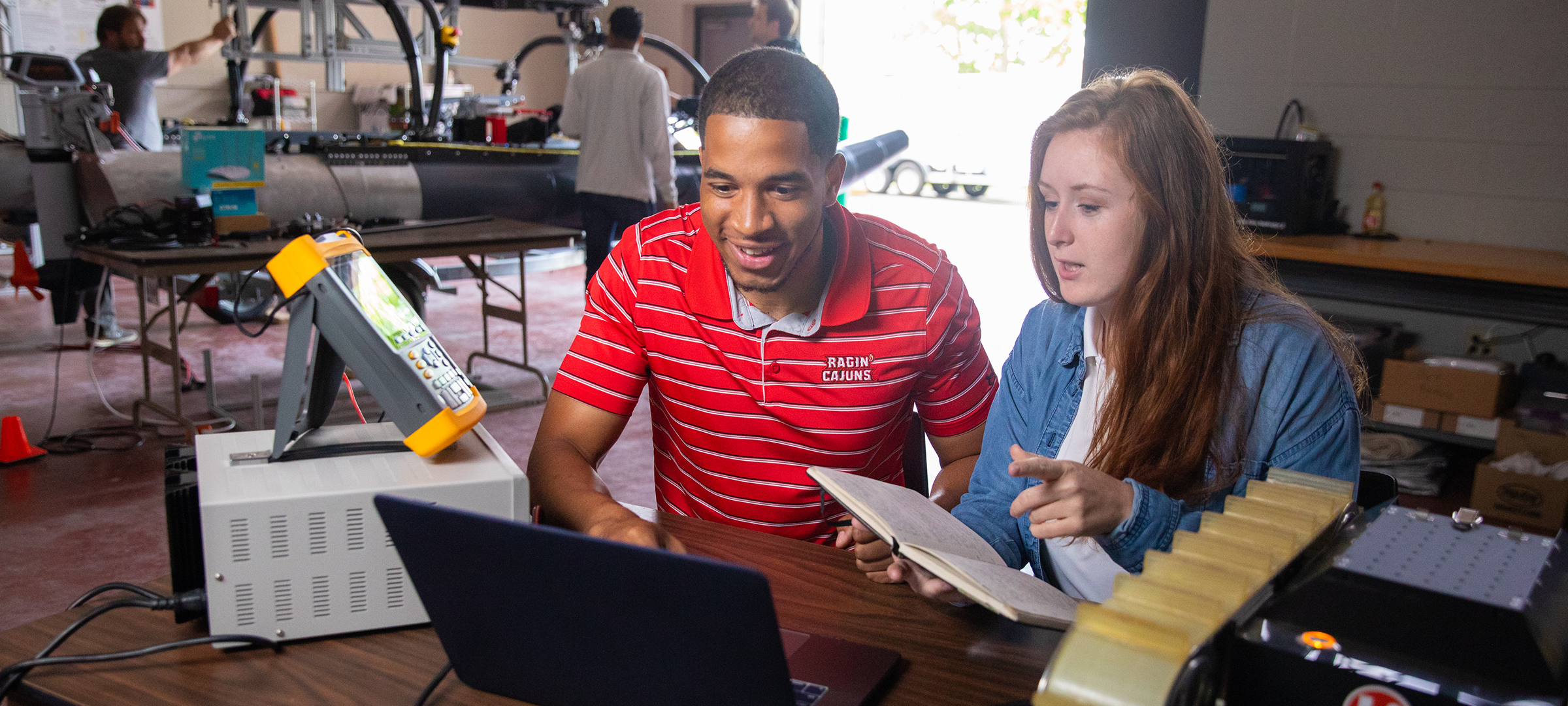 Two University of Louisiana at Lafayette students work on research under expert faculty in a lab