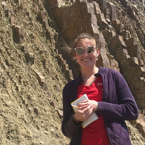 Geology major Abby Watson takes notes in the field during a geology trip