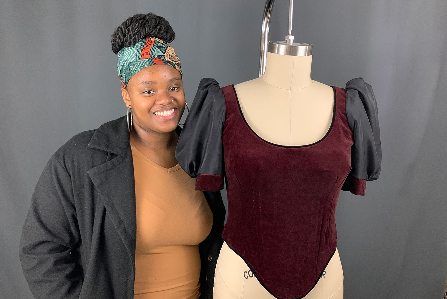 University of Louisiana at Lafayette acting student Imani Lecoq stands next to a costume she created for the theatre program