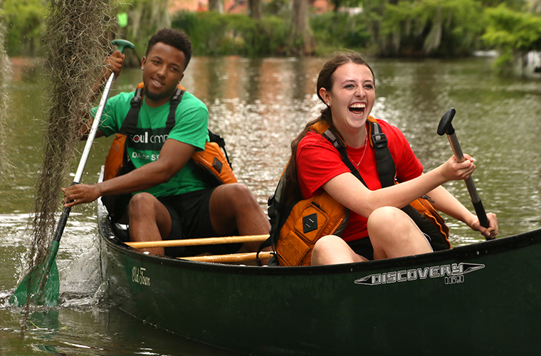 Students participate in canoe races in UL Lafayette's Cypress Lake