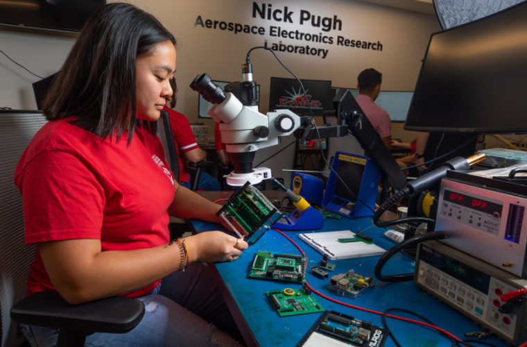 UL Lafayette electrical engineering student working on the CAPE satellite in the Nick Pugh Aerospace Electronics Research Laboratory.