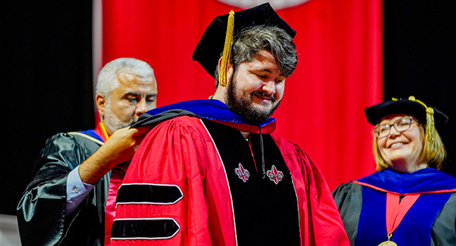 Ph.D. student being hooded at graduation