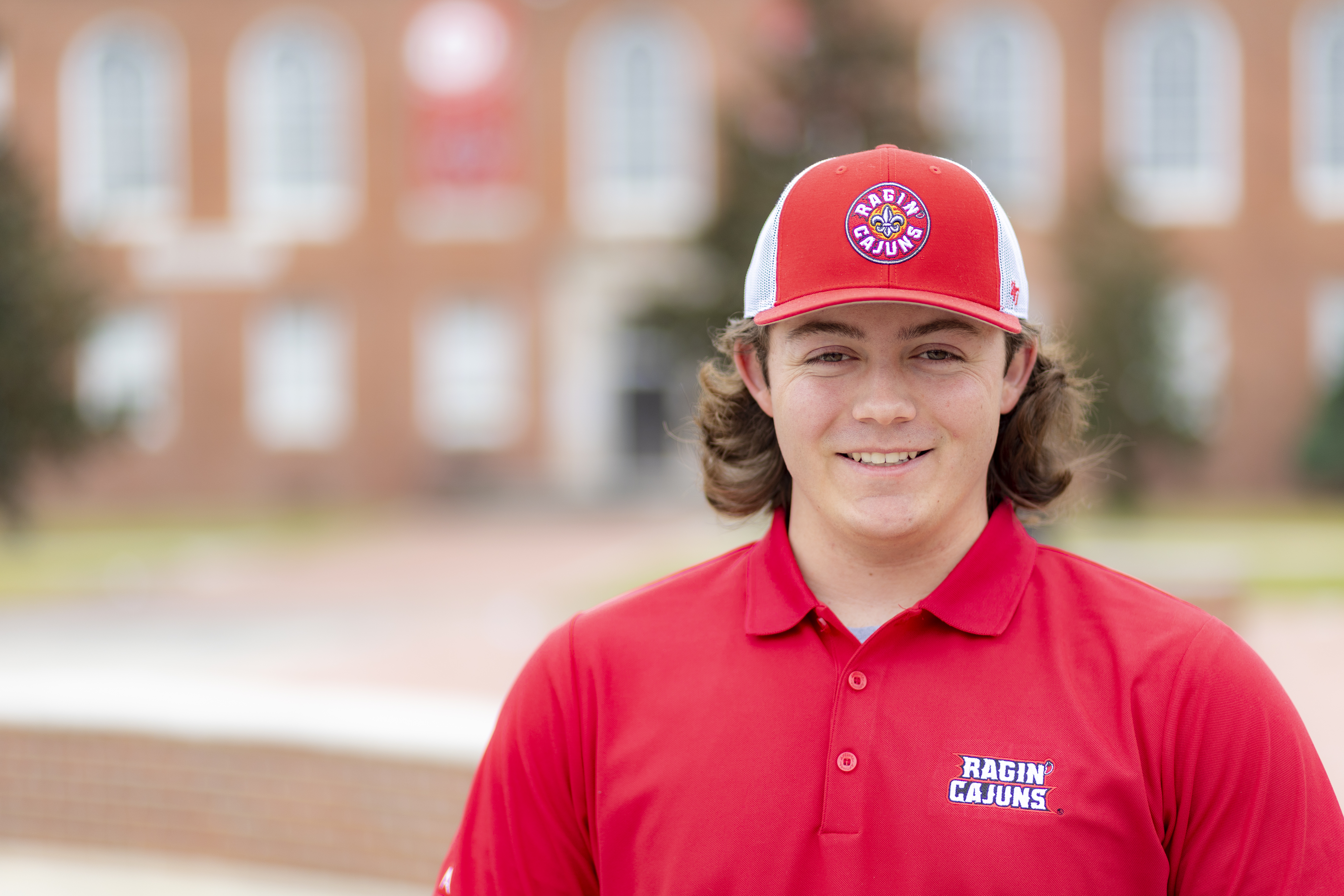Portrait photo of Conner Durand in front of the University of Louisiana at Lafayette.