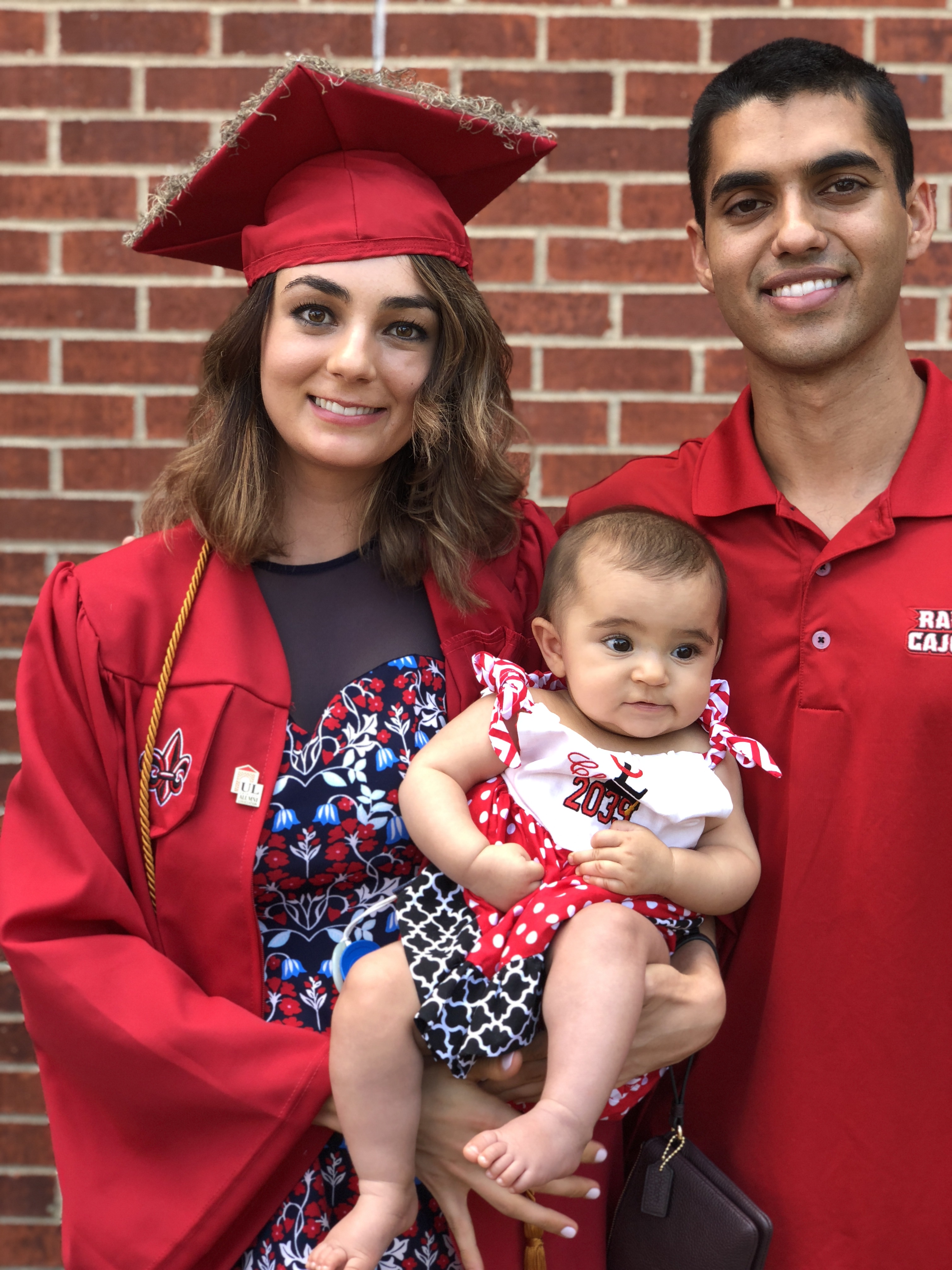 General Studies Online alumni Kailee Marikar is pictured with her husband and infant daughter following Spring 2018 commencement ceremonies.