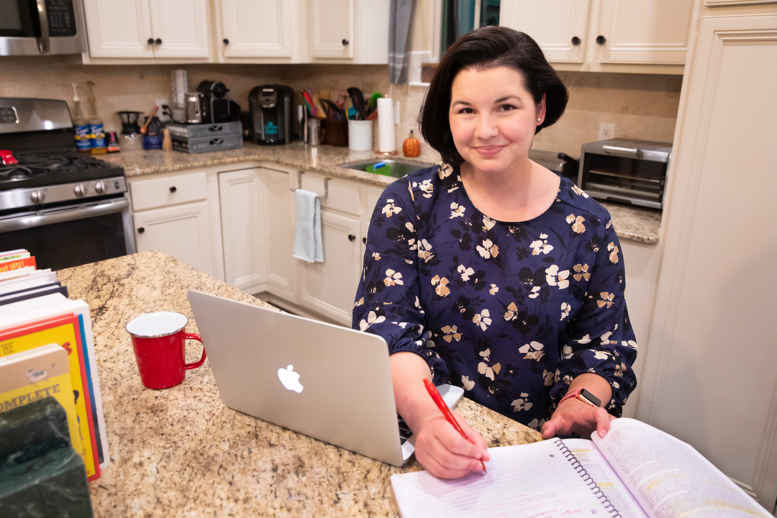 M.Ed. Special Education: Gifted alumna Dani Oldfield studies on a laptop at her kitchen bar.