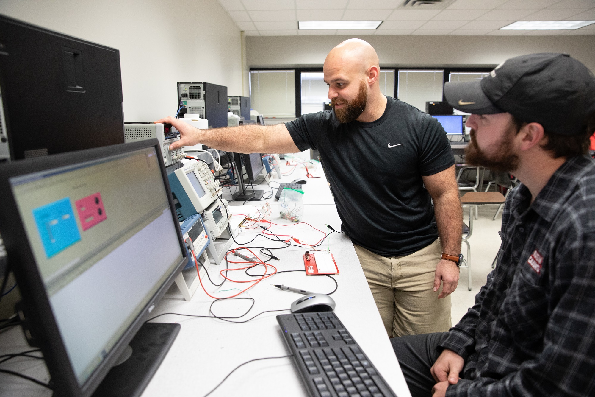 MS in Systems Technology alumn James Guillory is pictured working with technical equipment.