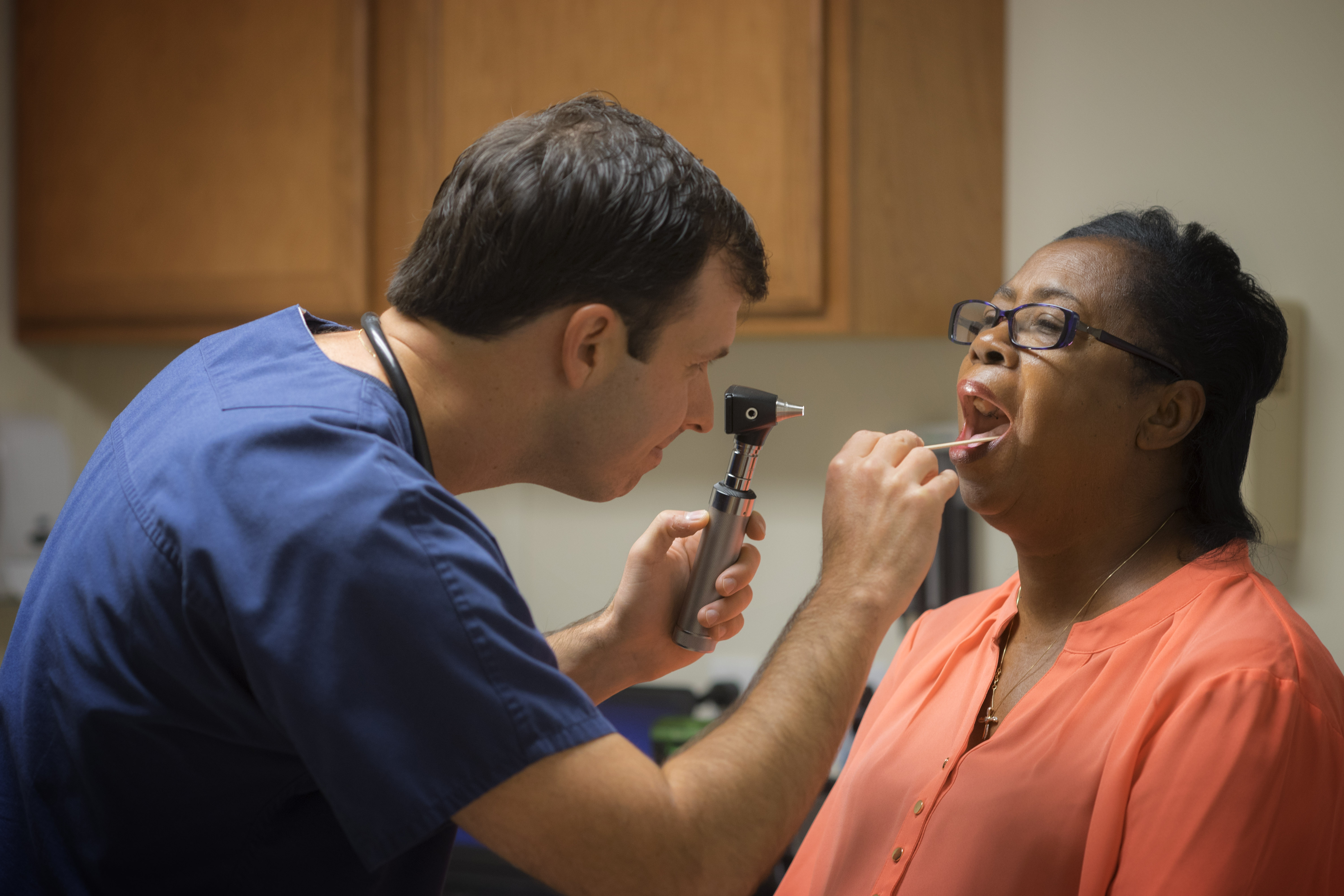 Elliot Myers examines a patient in his St. Landry Parish clinic. Myers earned his bachelor's, master's, and doctorate in nursing from UL Lafayette.