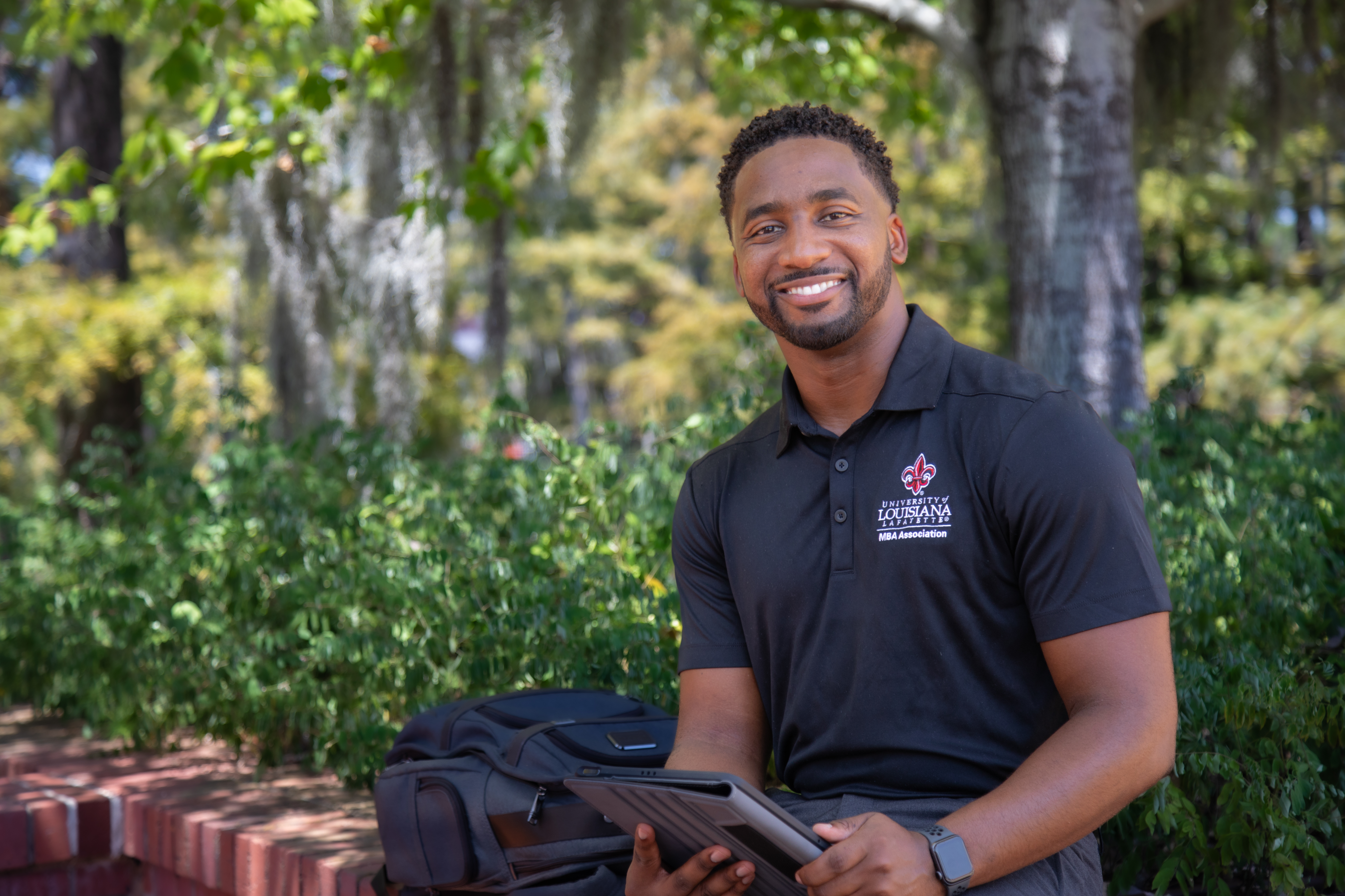 Ryan Owens is pictured outdoors near UL Lafayette's Cypress Lake. Owens earned his MBA online through UL Lafayette.