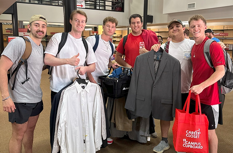 Students with their FREE professional clothing that they shopped from the Career Closet