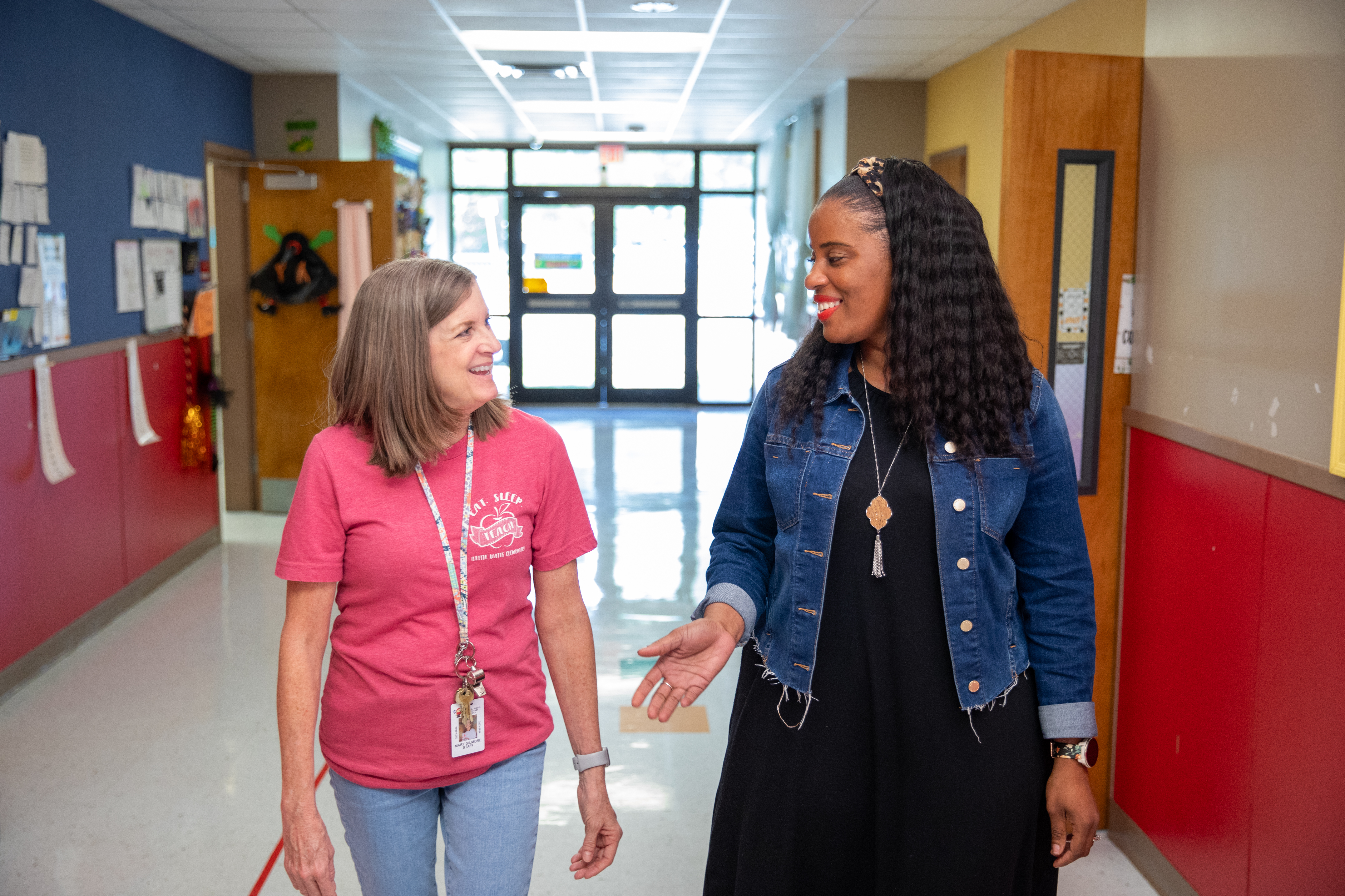 Rekeisha Treig walks with a colleague down the hall of her St. Mary Parish elementary school.