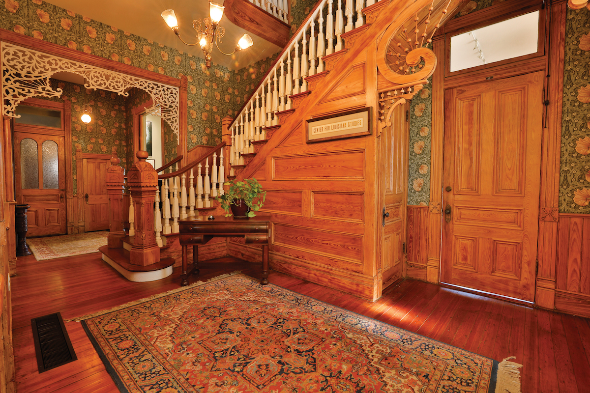 The ornate, Cypress staircase inside the vestibule of the Roy House.