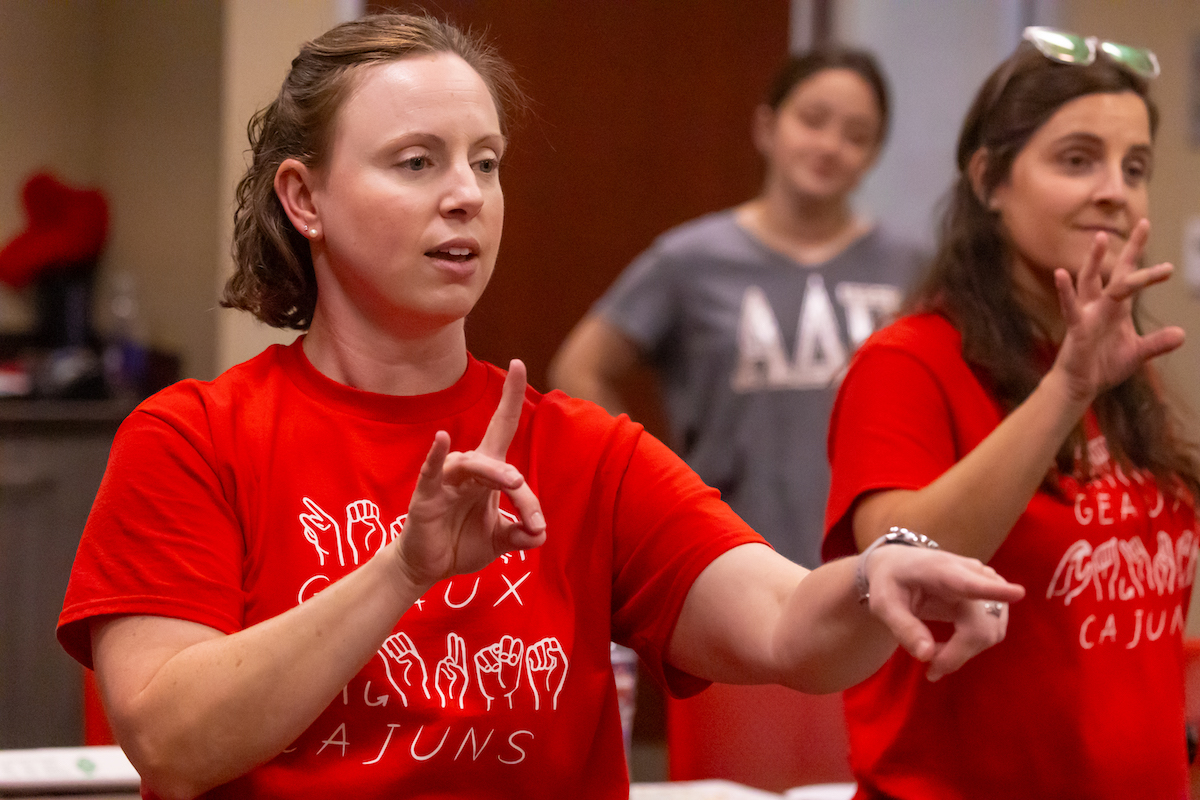 Katie Potier and Leah Dawsey, ASL instructors, teach children basic sign language vocabulary.