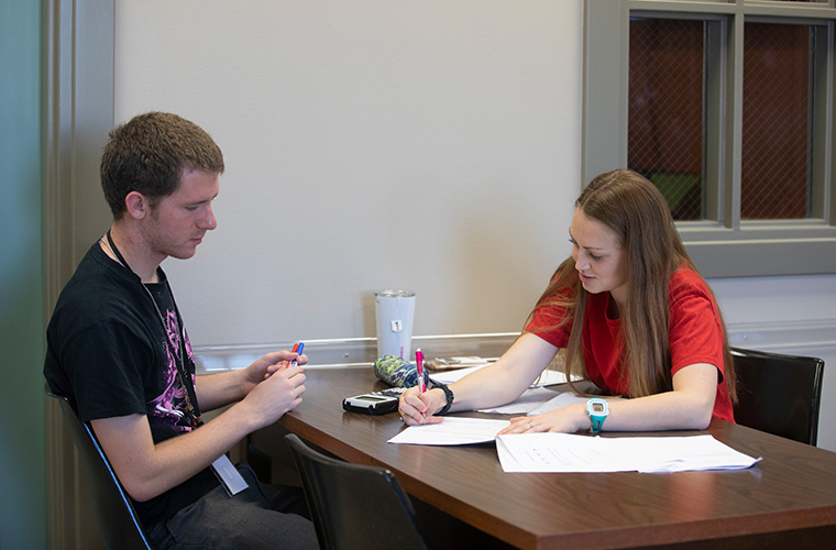 UL Lafayette students looking over schoolwork at the Academic Success Center.