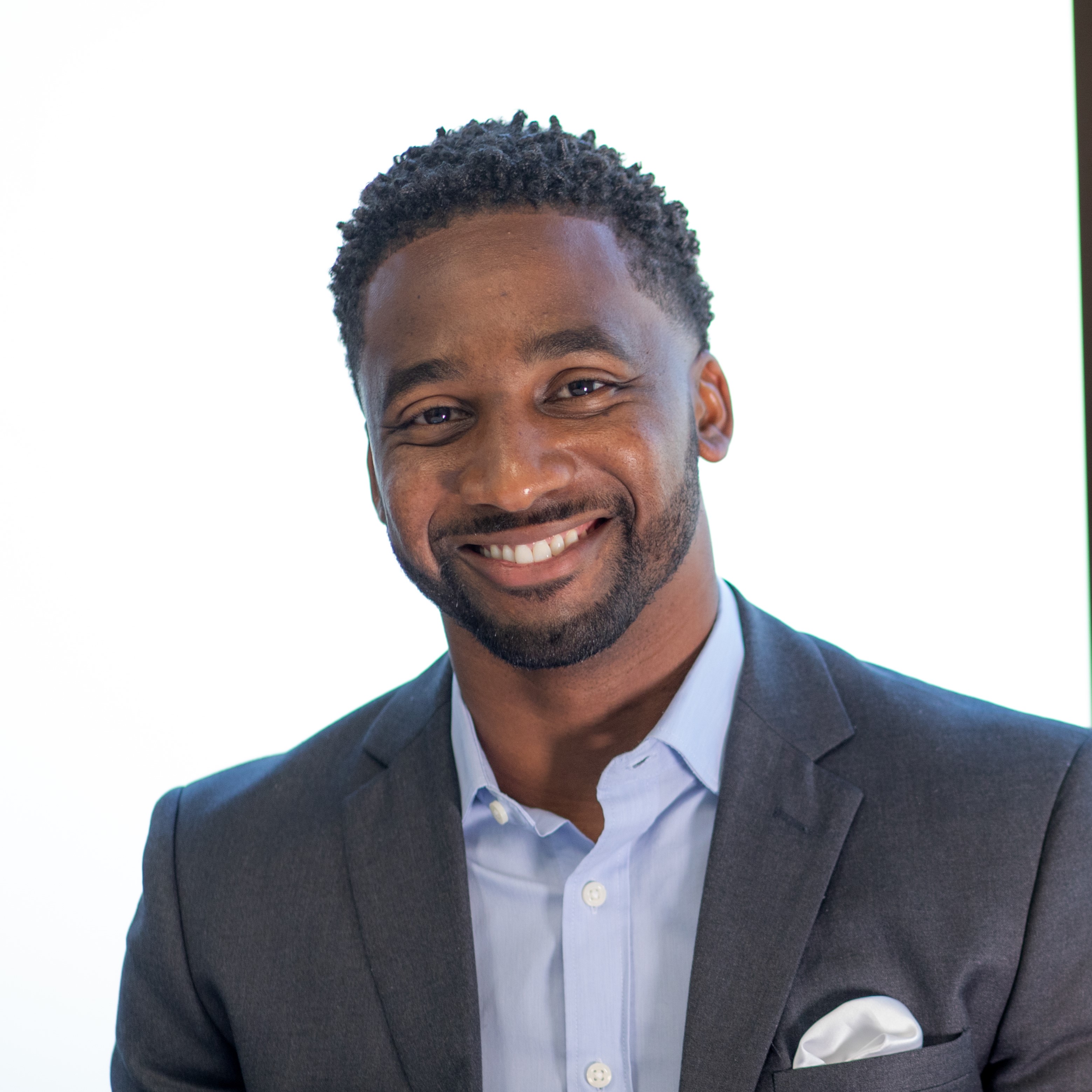 MBA grad smiles for a photo in formal work attire