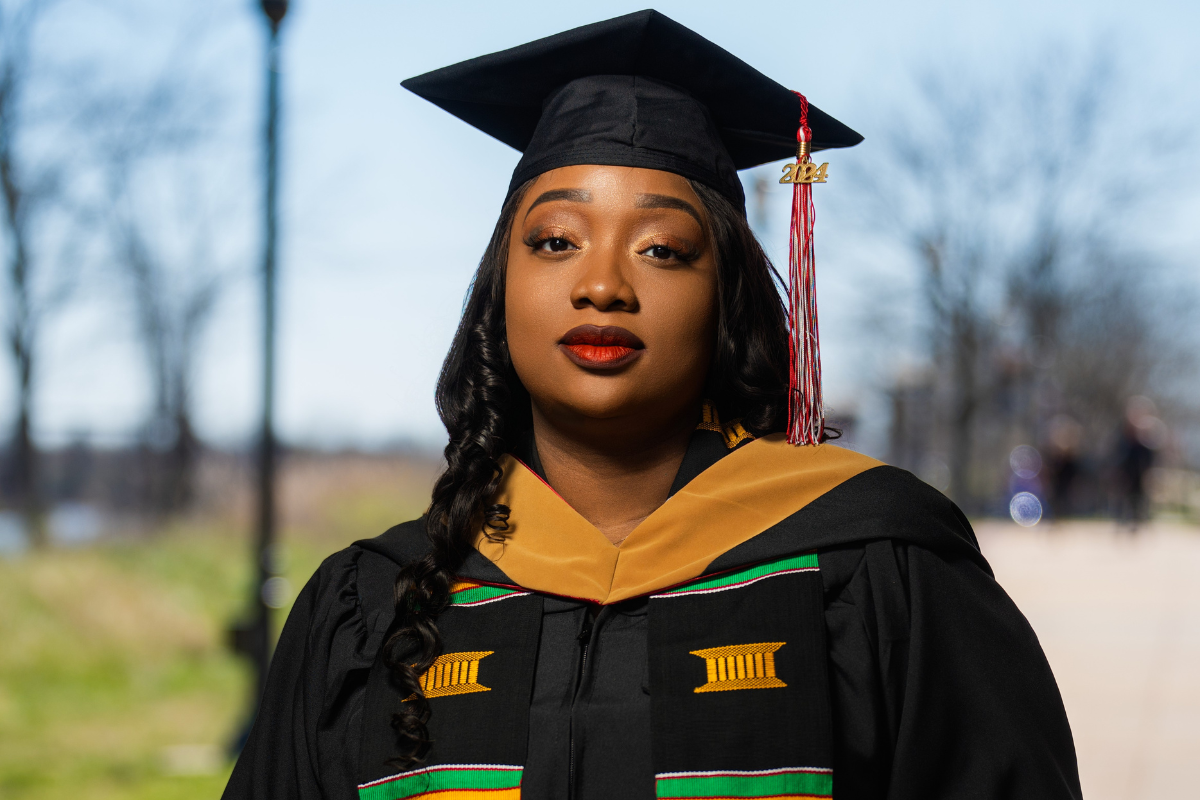 UL Lafayette MBA grad poses in black graduation attire