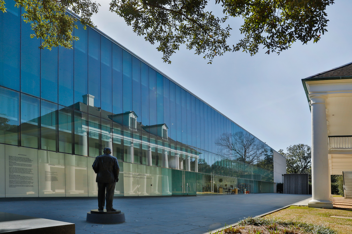 An exterior shot of the Hilliard Art Museum with a reflection of the A. Hays Town Building, located next to the museum.