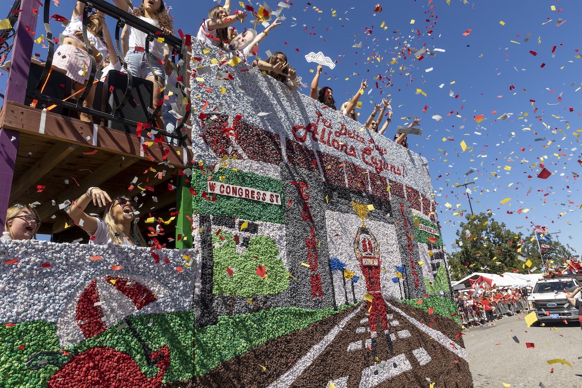 A float is covered in confetti as it rolls through the streets during the Homecoming Day Parade.