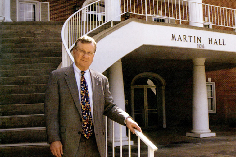 Dr. Savoie standing on Martin Hall stairs in 2008