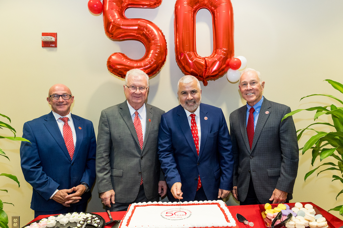 Drs. Jaimie Hebert, Joseph Savoie, Azmy S. Ackleh and Steve Landry cut a cake honoring the 50th anniversary of the College of Sciences.