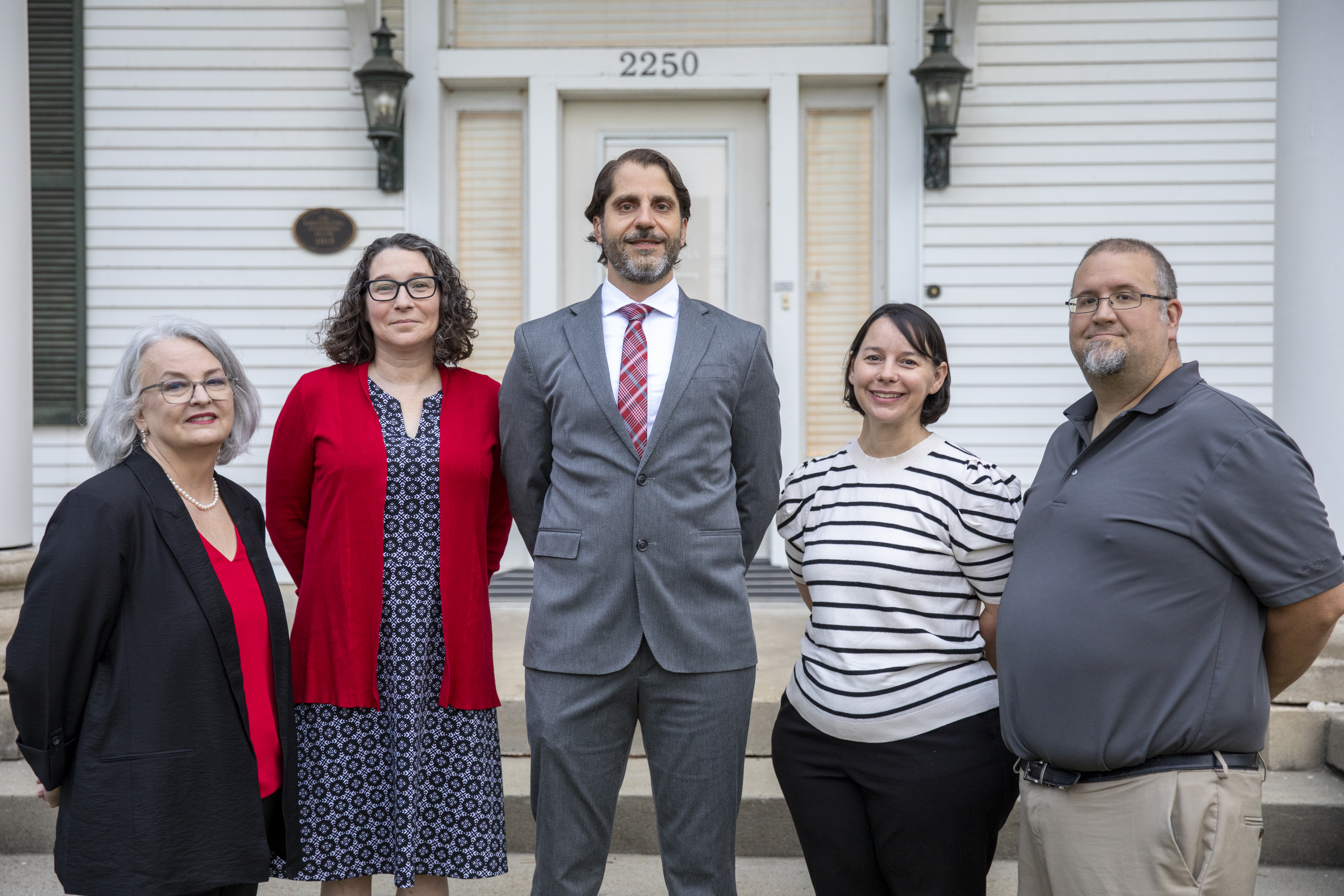 Members of the Distance Learning Instructional Support Team are pictured in front of their offices at Whittington House. From left to right are Renee Fiser, Andrea Leonard, Francesco Crocco, Alise Hagan, and Mike Williams.