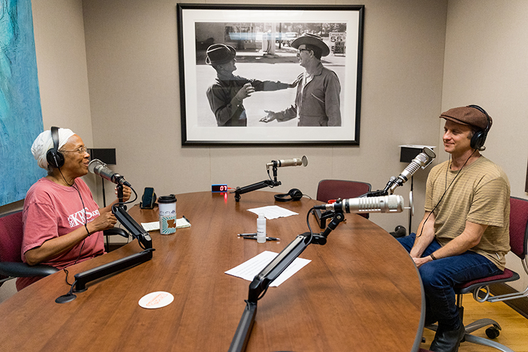 KRVS radio hosts speak into microphones