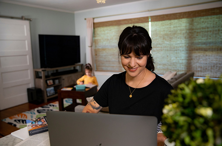 Student works on a professional certificate while at home with her daughter