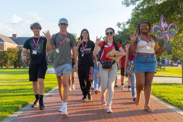 An Orientation Leader leads students on a tour of campus