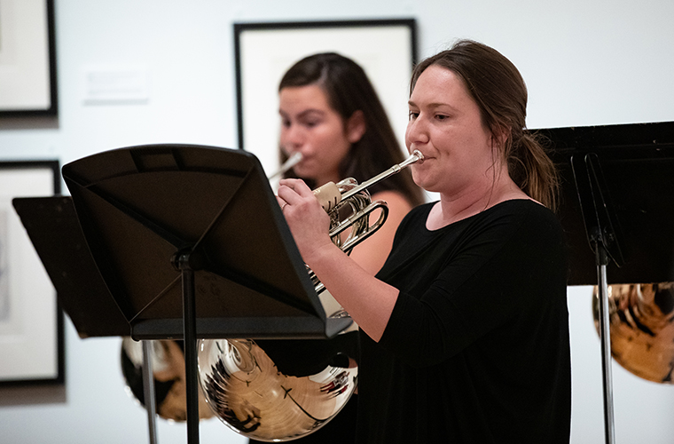 Female UL Lafayette student plays at trumpet during a performance