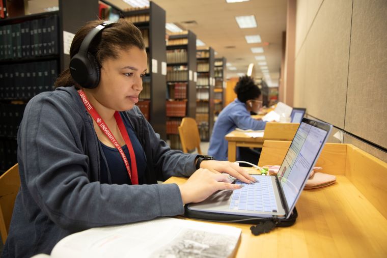 A student working on a laptop in the library 