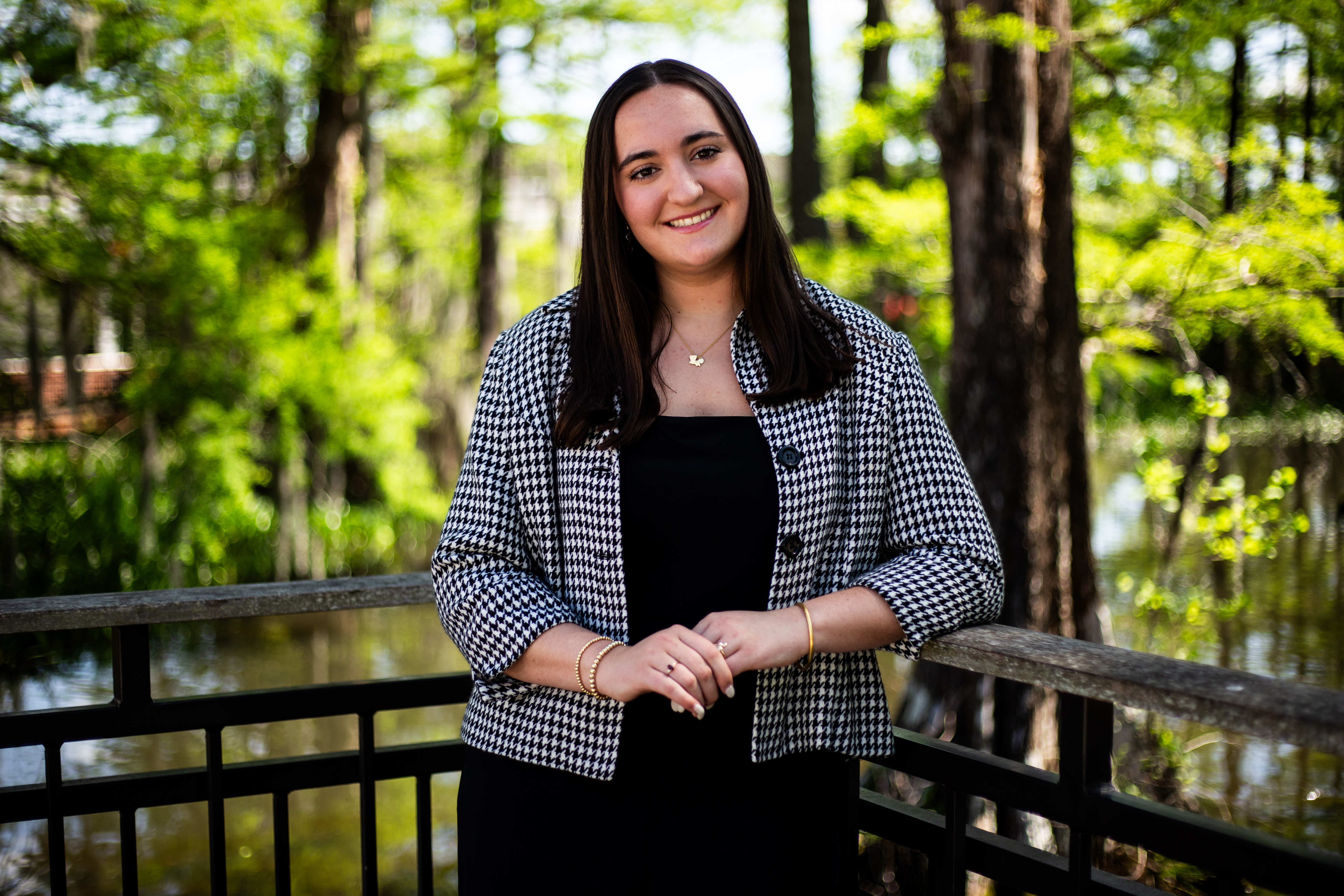 A professional portrait photo of Camille Brown in front of a lake on campus at the University of Louisiana at Lafayette.