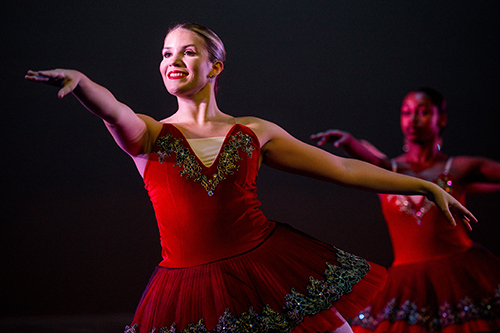 Ballet student poses in red tutu