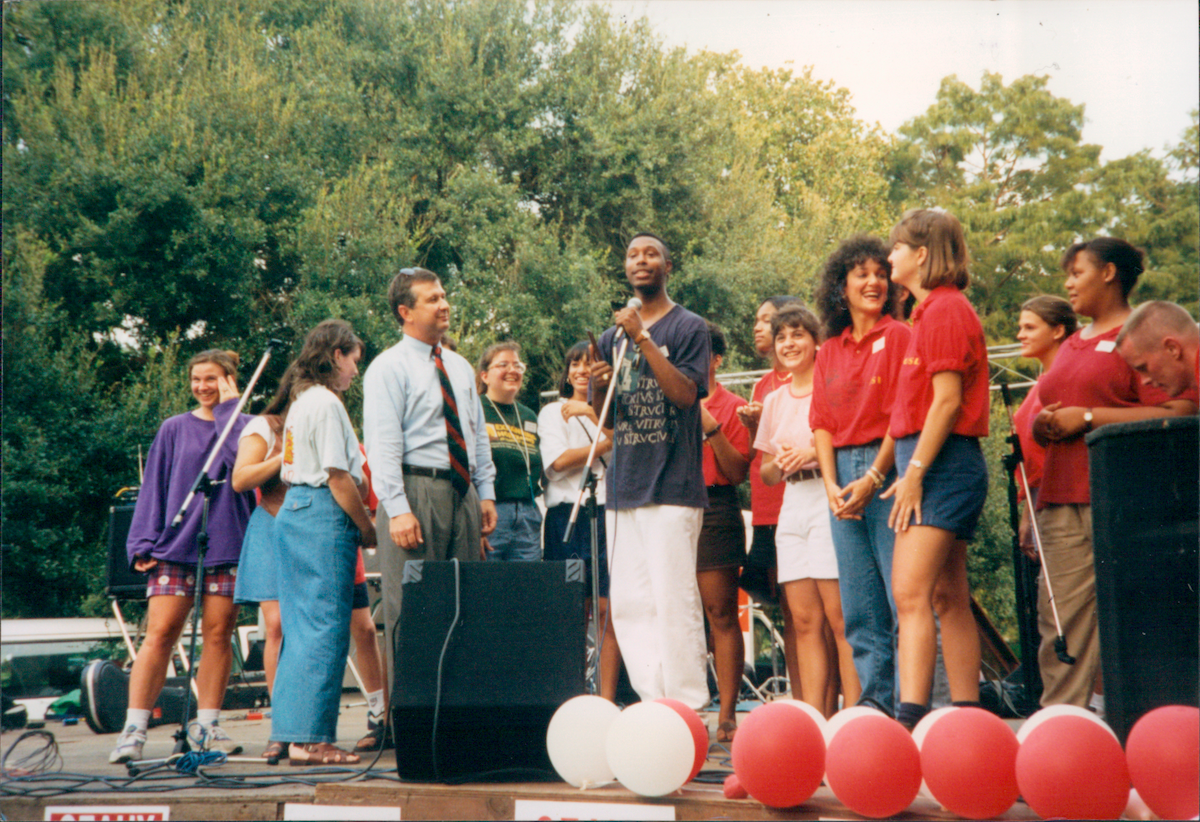 Dr. Joseph Savoie, left, began his career as assistant dean of student personnel at UL Lafayette. In this archive photo, he is standing on stage with students.