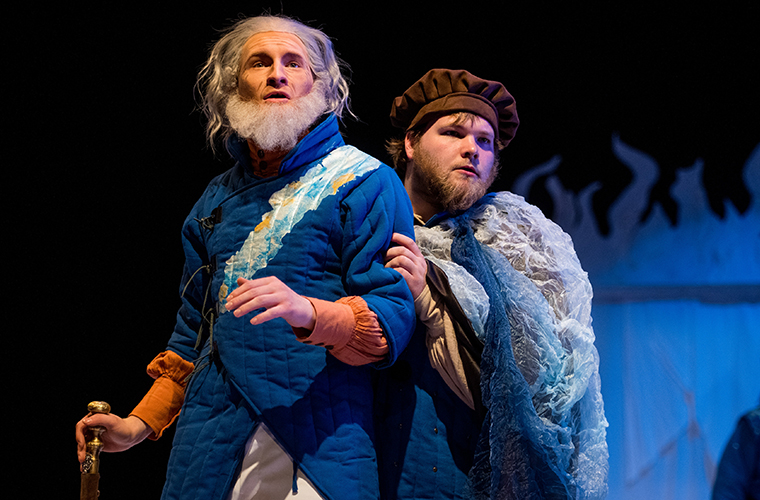 Two students in old men costumes gace to the east
